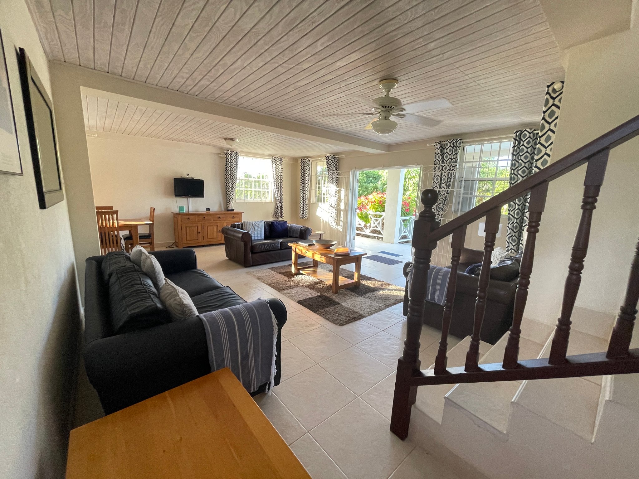 Holland Park Villa lounge from staircase with garden views and ceiling fan